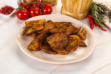 Golden baked potato Idaho with spices