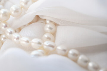 The tender arrangement of pearls on a gentle white cloth exudes a serene aesthetic. It's a quiet...