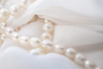 The tender arrangement of pearls on a gentle white cloth exudes a serene aesthetic. It's a quiet protest against the glaring, artificial visuals that dominate modern digital platforms.