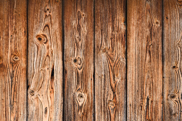 Fototapeta premium The background of the wall with the texture of boards painted with orange paint