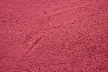Pink colored abstract wall background with textures of different shades of bright red