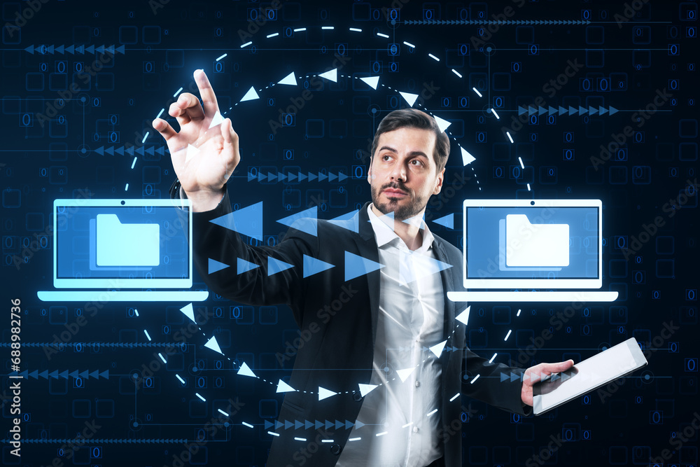 Poster Attractive young caucasian businessman with pad using creative digital data transfer and exchange folders on dark background. Backup data, virtual document storage or loading on cloud service.
