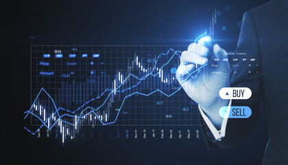 Close up of businessman hand pointing at creative candlestick trading graph on blurry background....