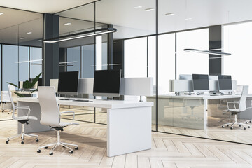 Clean glass coworking office interior with wooden flooring, panoramic windows and city view, furniture, equipment and computer monitors. 3D Rendering.