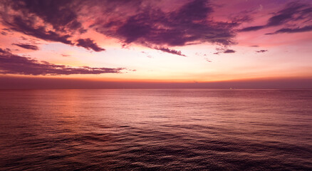 Naklejka na ściany i meble Amazing sunset or sunrise sky over sea landscape,Beautiful colorful light of nature seascape background,Drone aerial view ocean background