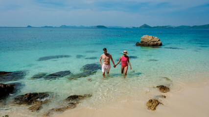 A couple of men and woman at Ko Kham tropical Island Sattahip Chonburi Samaesan Thailand
