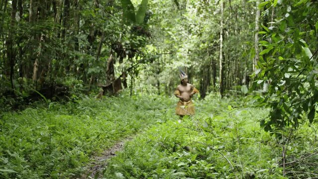 Native guy walk on a trail in the dense forest in Leticia, Amazon, Colombia