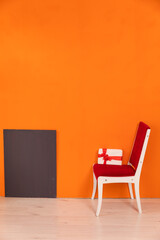 One Chair With Holiday Gift Against Bright Colored Wall
