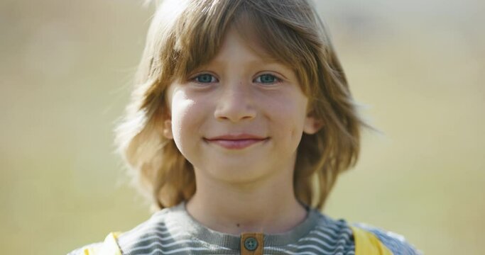 Boy kid tourist smiling happily, portrait. Showing joy of discovery during adventure on camper, child smiles. Cute camper boy child tourist, actively exploring world, ready for new journeys adventures