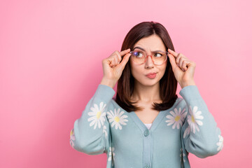 Photo of suspicious unsure woman dressed teal outfit arms eyeglasses looking empty space isolated pink color background