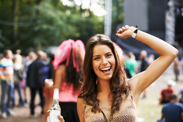 Music, festival and portrait of woman at a concert, stage and celebration with alcohol, bottle or beer at event. Happy, girl and dancing at party with audience, crowd and excited fan at techno rave - Powered by Adobe