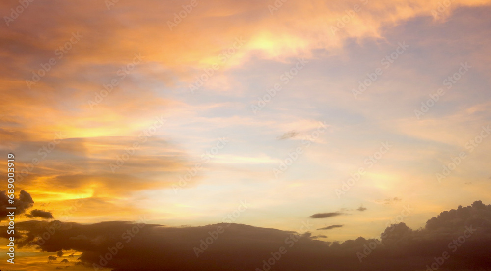 Wall mural sunset in the clouds. sunset sky. the sun's rays scatter in the clouds during sunset.