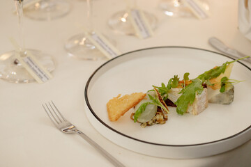 Cheese platter with wine glass in the background. Wine dinner. Assortment of French cheese.