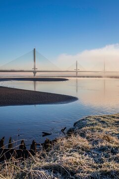 Cable-Stayed River Crossing Mersey Gateway Bridge in winter with fog