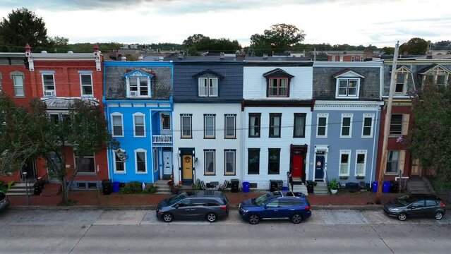 Colorful rowhomes in USA city. Aerial truck shot of urban living establishing shot.