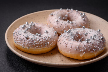 Delicious fresh donut of white or beige color with silver beads and cream