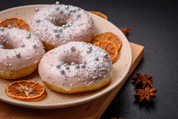 Delicious fresh donut of white or beige color with silver beads and cream