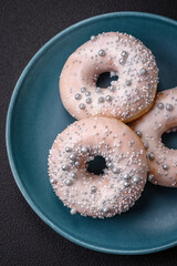 Delicious fresh donut of white or beige color with silver beads and cream