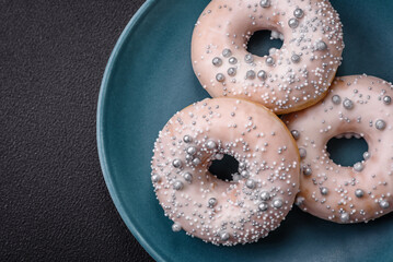 Delicious fresh donut of white or beige color with silver beads and cream