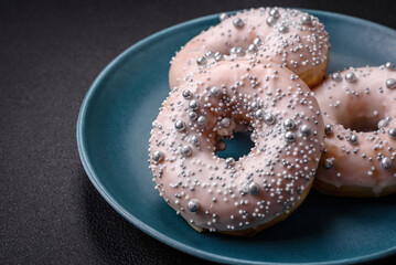 Delicious fresh donut of white or beige color with silver beads and cream