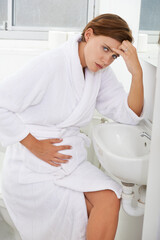 Nausea, pregnant woman and morning sickness in bathroom, unhappy and hand on stomach. Mirror...