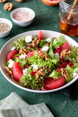 Salad with grapefruit, white cheese, pomegranate and nuts. Healthy eating. Vegetarian food. Diet.