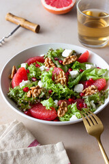Salad with grapefruit, white cheese, pomegranate and nuts. Healthy eating. Vegetarian food. Diet.