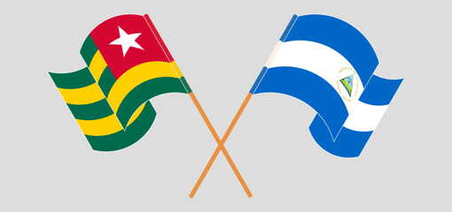 Crossed and waving flags of Togo and Nicaragua