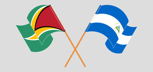 Crossed and waving flags of Guyana and Nicaragua