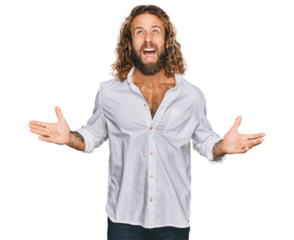 Handsome man with beard and long hair wearing casual clothes crazy and mad shouting and yelling with aggressive expression and arms raised. frustration concept.
