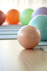 Empty Pilates or gymnastics room with mat and large gymnastic rubber balls for exercise and physical therapy. Colored exercise balls.