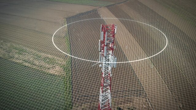 5G mobile tower station with graphics of microwave pollution and binary code. Aerial view over a plowed land 