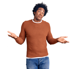 Handsome african american man with afro hair wearing casual clothes clueless and confused expression with arms and hands raised. doubt concept.