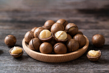 Close up macadamia nuts on wooden background.