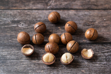 Close up macadamia nuts on wooden background.