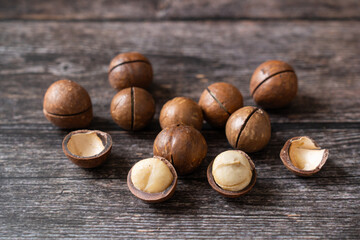 Close up macadamia nuts on wooden background.