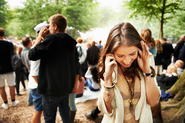 Music festival, event and woman outdoor with phone call, conversation and noise from crowd at a party. Contact, person and confused by loud, sound or listening to smartphone for communication at rave - obrazy, fototapety, plakaty