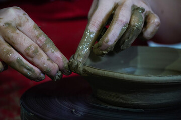 Pottery. The oldest trade from Daco-Roman times. Hands dirty with clay. Ceramics. Modeling in clay. Color and black-and-white detail photos.