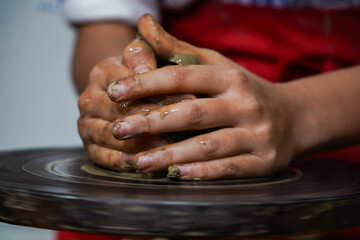 Pottery. The oldest trade from Daco-Roman times. Hands dirty with clay. Ceramics. Modeling in clay. Color and black-and-white detail photos.