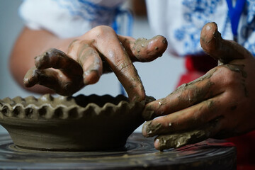 Pottery. The oldest trade from Daco-Roman times. Hands dirty with clay. Ceramics. Modeling in clay. Color and black-and-white detail photos.