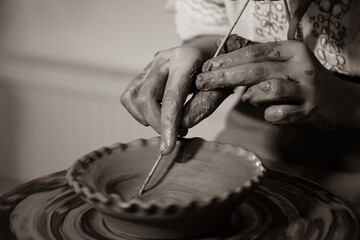 Pottery. The oldest trade from Daco-Roman times. Hands dirty with clay. Ceramics. Modeling in clay. Color and black-and-white detail photos.