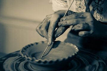 Pottery. The oldest trade from Daco-Roman times. Hands dirty with clay. Ceramics. Modeling in clay. Color and black-and-white detail photos.