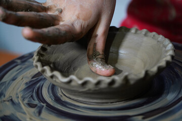 Pottery. The oldest trade from Daco-Roman times. Hands dirty with clay. Ceramics. Modeling in clay. Color and black-and-white detail photos.