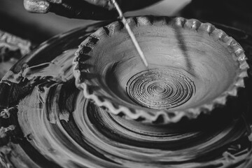 Pottery. The oldest trade from Daco-Roman times. Hands dirty with clay. Ceramics. Modeling in clay. Color and black-and-white detail photos.