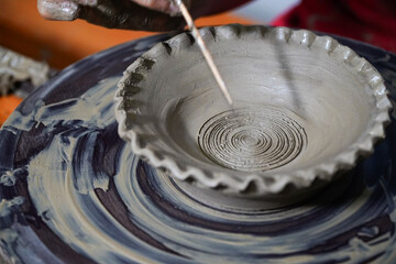 Pottery. The oldest trade from Daco-Roman times. Hands dirty with clay. Ceramics. Modeling in clay. Color and black-and-white detail photos.