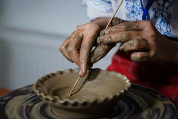 Pottery. The oldest trade from Daco-Roman times. Hands dirty with clay. Ceramics. Modeling in clay. Color and black-and-white detail photos.