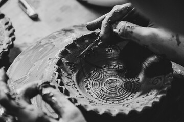 Pottery. The oldest trade from Daco-Roman times. Hands dirty with clay. Ceramics. Modeling in clay. Color and black-and-white detail photos.