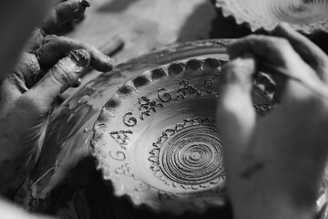 Pottery. The oldest trade from Daco-Roman times. Hands dirty with clay. Ceramics. Modeling in clay. Color and black-and-white detail photos.