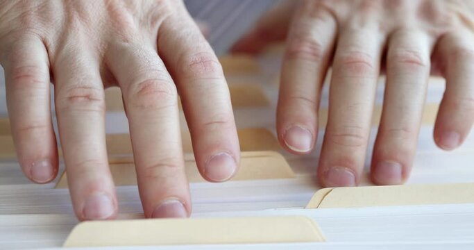 Male hands are going through large pile of documents. Introduction of company financial statements concept