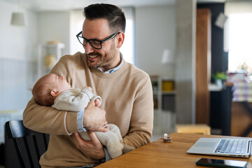 Portrait of young father holding his newborn baby. Fatherhood love single dad fathers day concept.